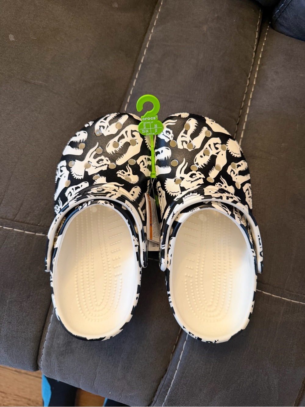 New with tags kids size j 2. Glow in the dark dinosaur crocs.